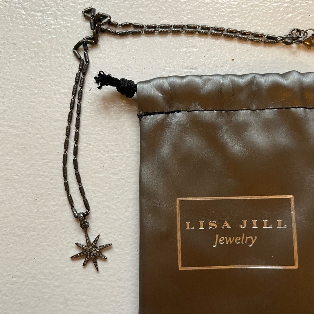 Star burst charm pendant necklace. Unworn- includes jewelry bag and tag